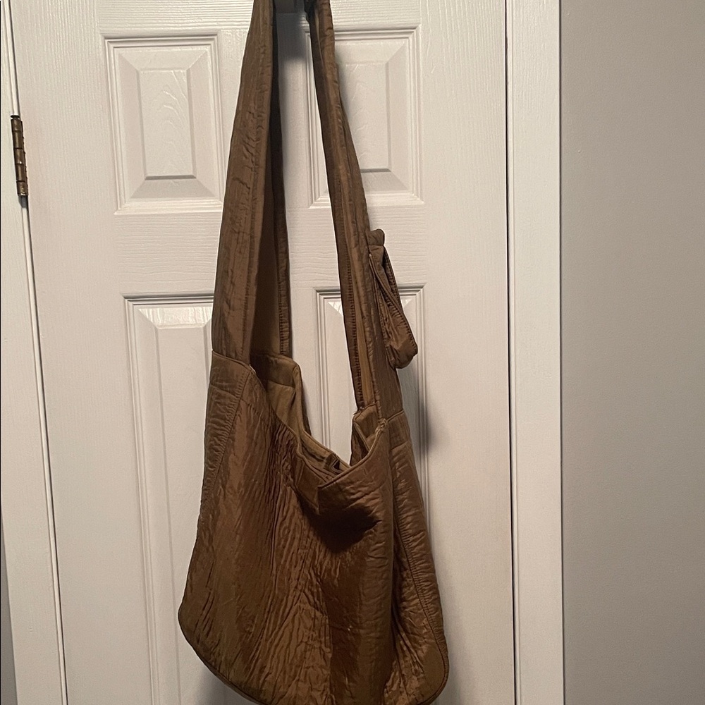Free People Beach Bag In a Bronze color. There is a flaw by the strap.